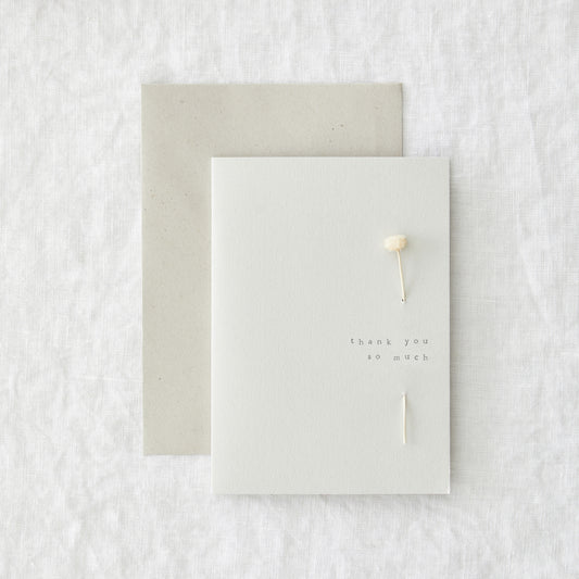Thank you card in speckled cream paper reading 'thank you so much', shown with its envelope