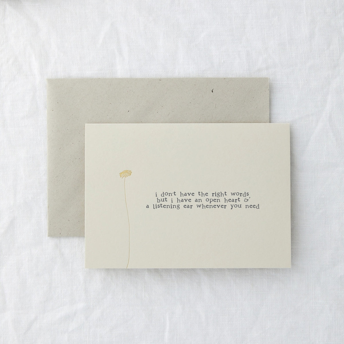Thinking of You card in cream paper lying flat with its envelope on a soft white surface