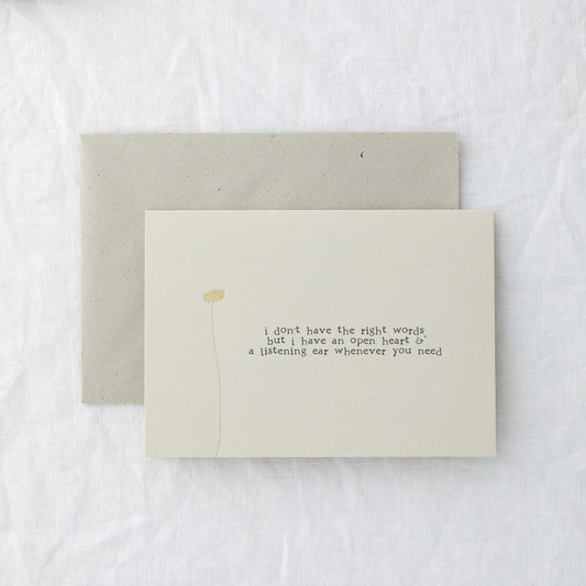Thinking of You card in cream paper lying flat with its envelope on a soft white surface