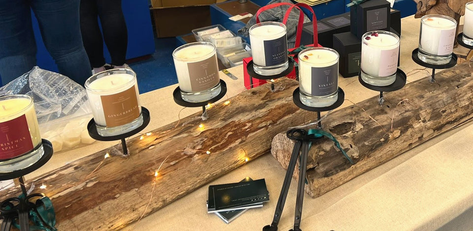 Little London Gifts Co candles on a driftwood stand at a school Christmas fair