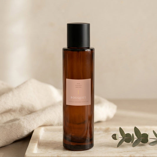 Bouquet room spray 100ml, amber glass bottle on a marble tray with linen and eucalyptus