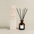 Load image into Gallery viewer, English Bluebell 95ml reed diffuser, amber glass bottle and black reeds next to a blush dried-flower gift box
