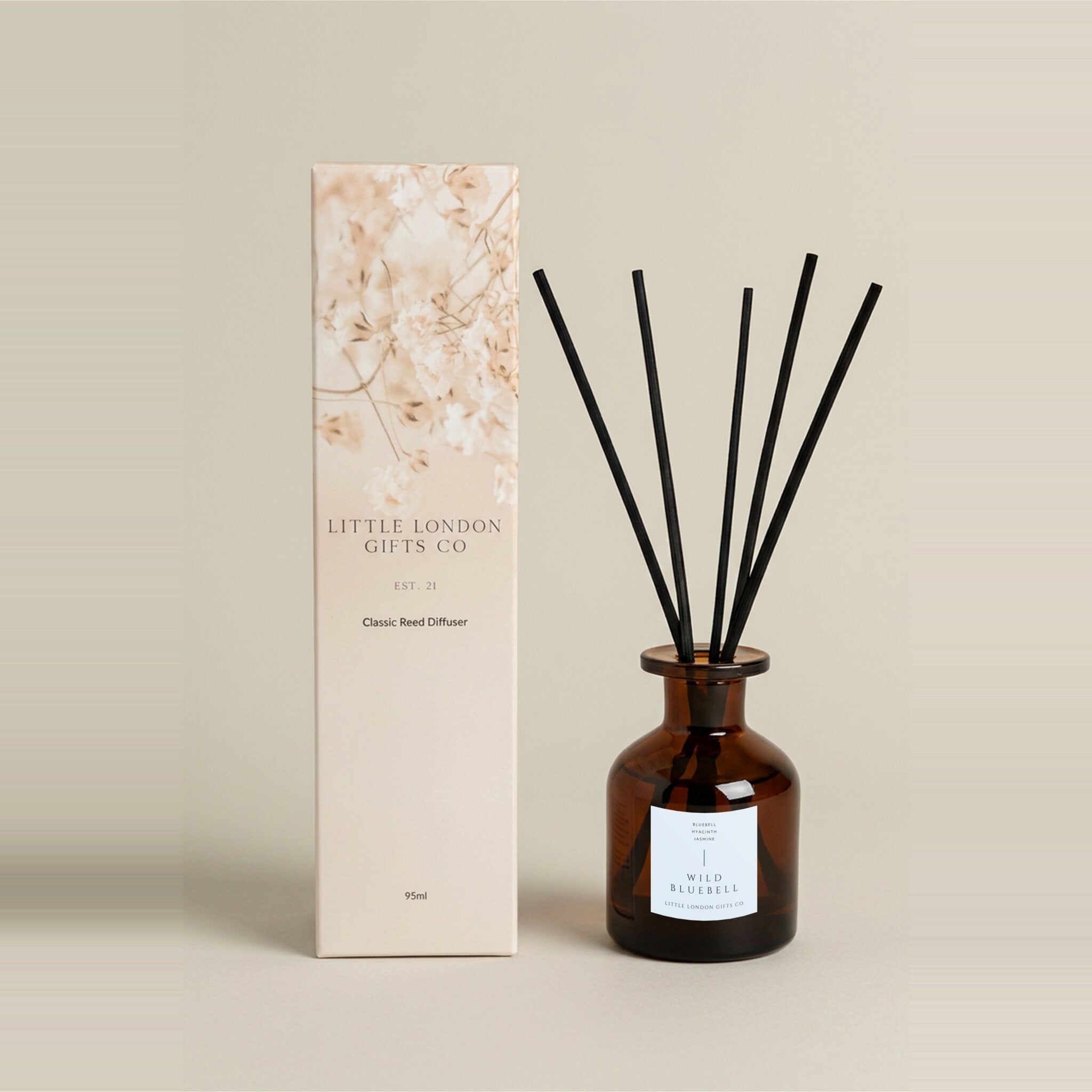 English Bluebell 95ml reed diffuser, amber glass bottle and black reeds next to a blush dried-flower gift box
