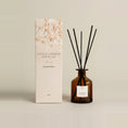 Load image into Gallery viewer, Mandarin & Ginger 250ml reed diffuser in amber glass, black reeds fanned above a cream dried-flower gift box
