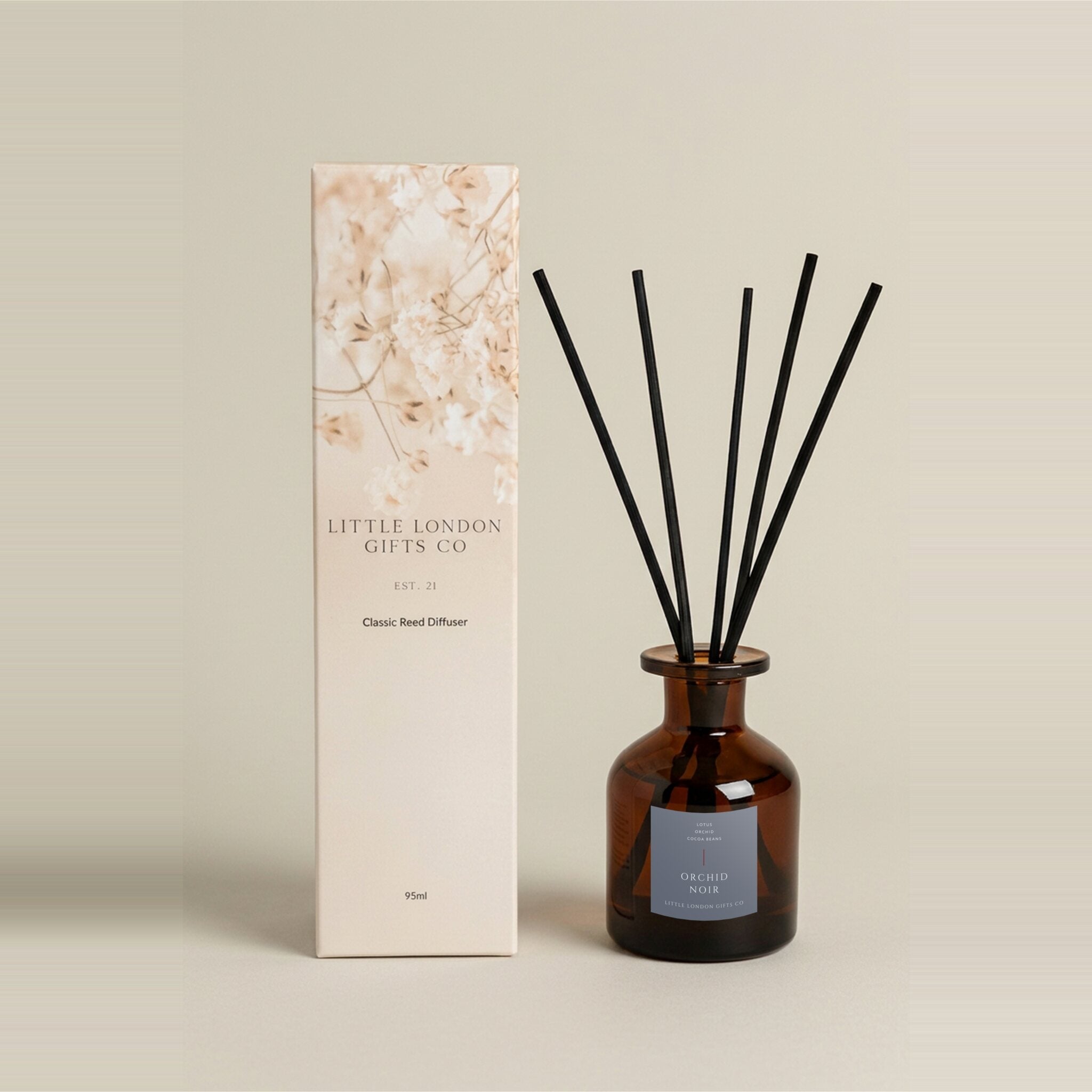 Orchid Noir 95ml reed diffuser in amber glass with a lilac label, black reeds, and a cream dried-flower gift box