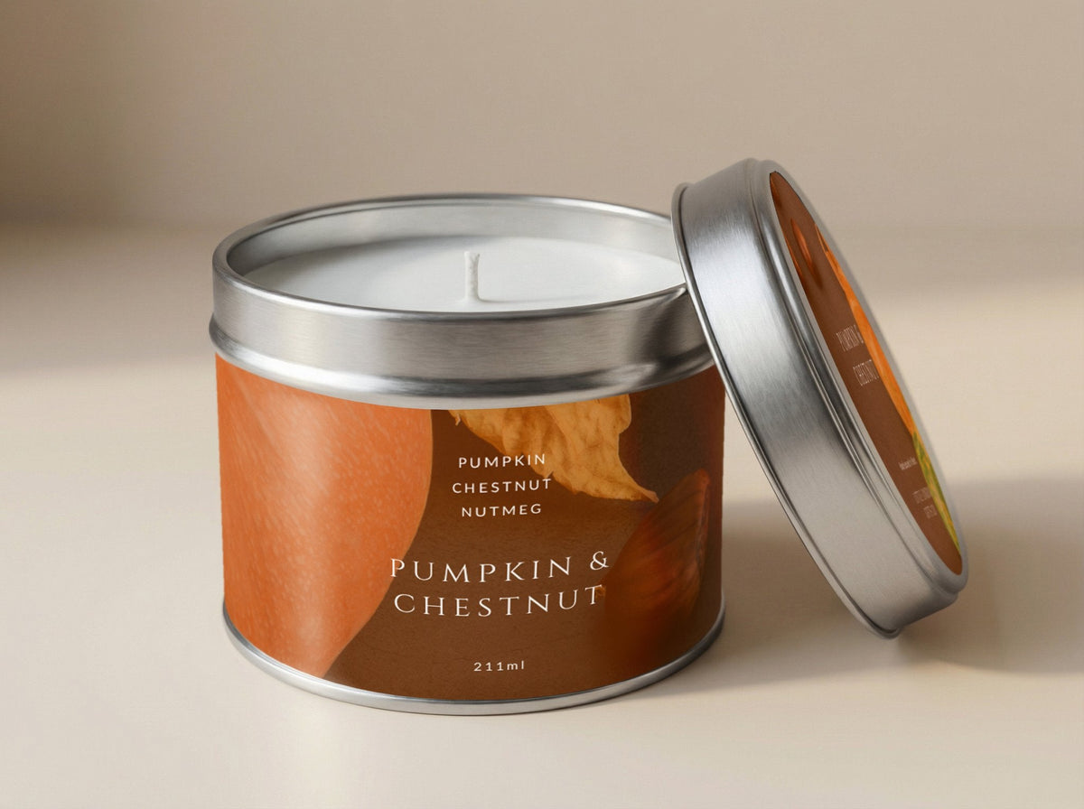 Pumpkin & Chestnut candle tin 211ml open, showing the pale wax and cotton wick, silver lid propped beside it