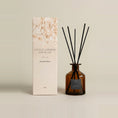 Load image into Gallery viewer, Vintage Dark Honey 250ml reed diffuser in amber glass with a charcoal label, black reeds and a cream gift box
