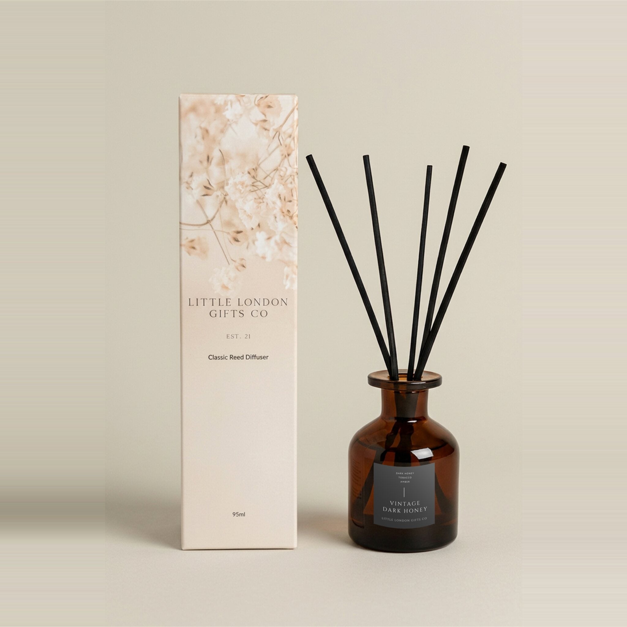 Vintage Dark Honey 95ml reed diffuser, amber bottle with a navy label, black reeds and a cream floral gift box