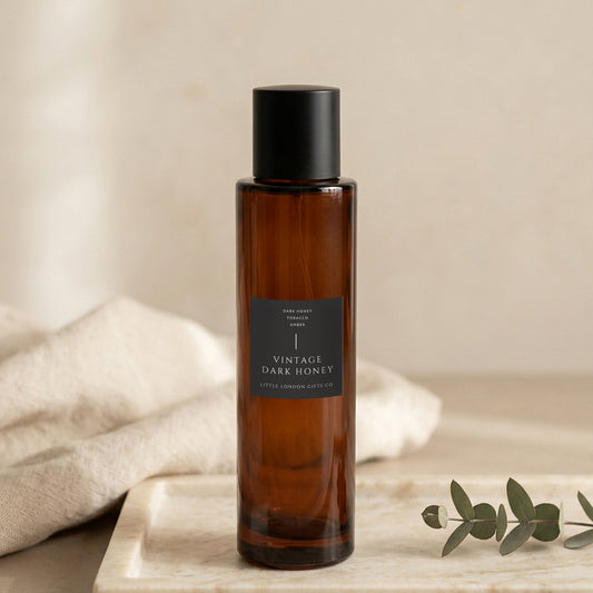 Vintage Dark Honey room spray 100ml, amber glass bottle on a marble tray with linen and eucalyptus